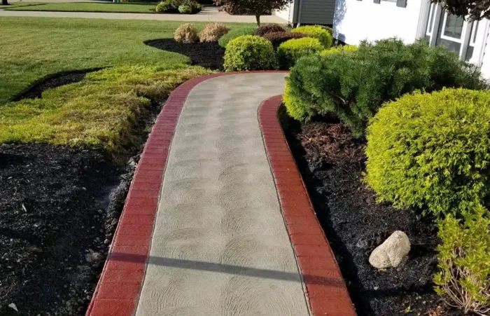 Concrete Walkway With A Decorative Red Edge