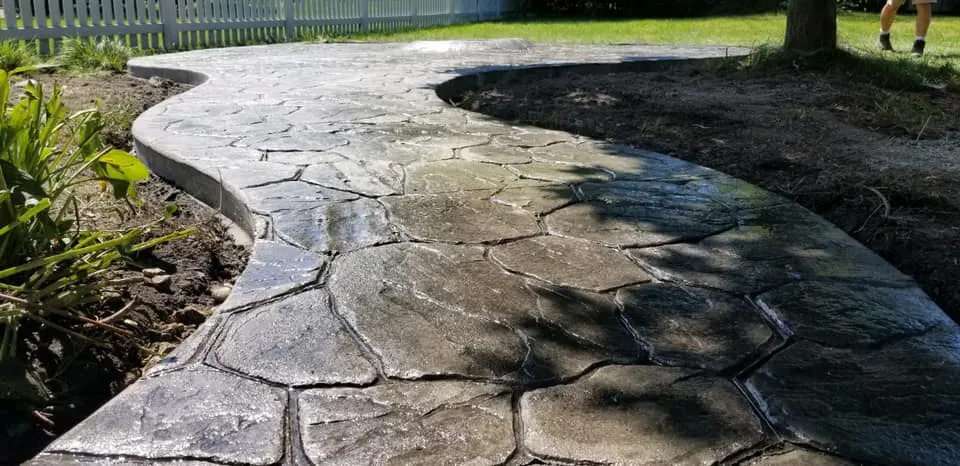 beautiful brownish stamped concrete walkway that looks like flagstone.