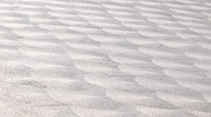 Beautiful concrete floor with a hand-swirled finish and sun shining on it.