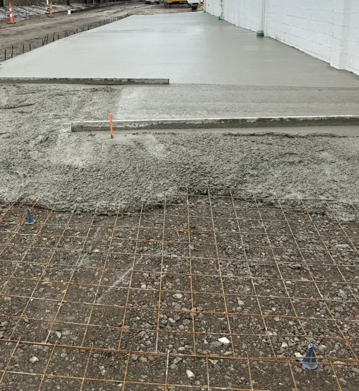 Large concrete commercial floor in the process of being poured.